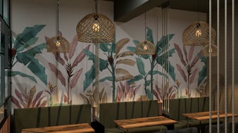 a restaurant with a wall mural of tropical plants