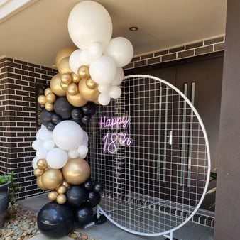 Circle mesh backdrop with happy 18th neon and balloon garland at birthday in Loganholme.