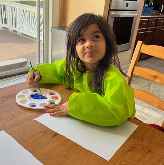 Photo of young child painting at the daycare.