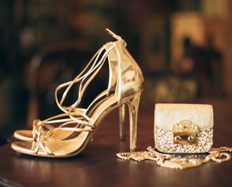 a pair of shoes and a purse on a table