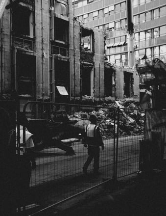 a worker walking down a street in a city