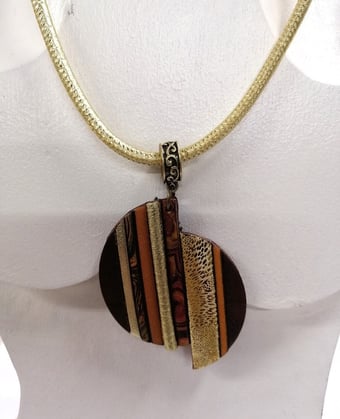 a necklace with a striped necklace on a mannequin