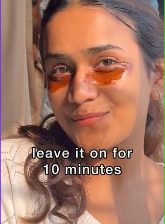 girl using coffee and honey mask under eyes