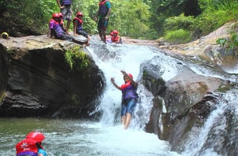 Sliding down a water fall wearing PPE is thrilling and fun