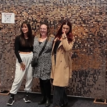 3 ladies in front of the rose gold shimmer wall hired for the Sass and Soul burlesque show at HOTA, Gold Coast