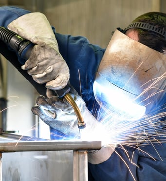 Welder wearing safety gear