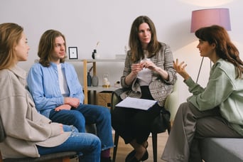 A group of people sitting around a table for a group nutrition counseling session