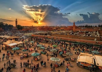 a large group of people standing around a market