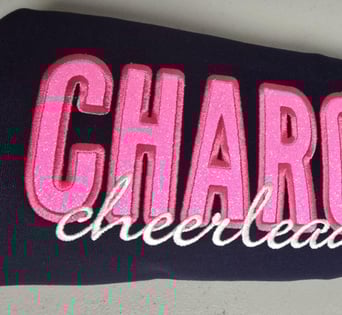 Custom glitter appliqué embroidery in pink & white thread on navy fabric – cheer spirit San Antonio