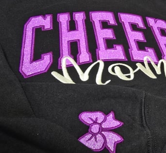 Custom glitter appliqué embroidery purple & white thread on navy fabric – cheer spirit San Antonio