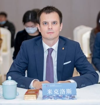 a man in a suit and tie sitting at a table