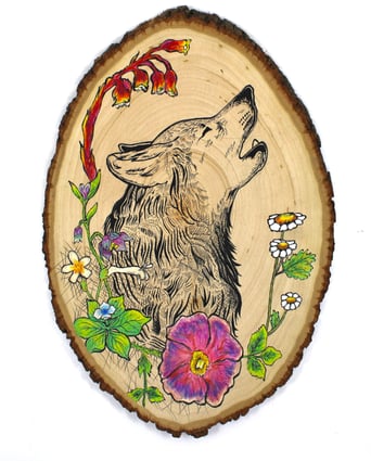 a drawing of a wolf and flowers on a wood slice