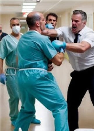 a doctor wearing a scrub attaccked by a patient in the hospital