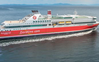 a large boat with a red and white boat in the water