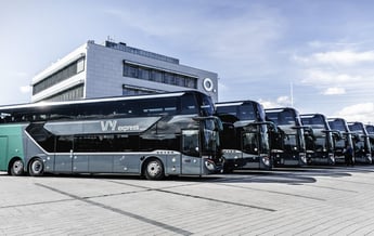 a group of buses parked in front of a building