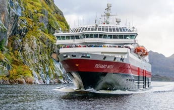 a large boat is coming down the river