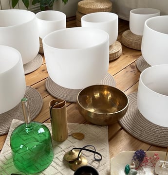 a selection of crystal singing bowls and sound instruments