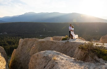 Bride and Groom standing on the edge of hoodoos in Fairmont Hot springs