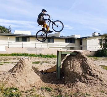 Mountain biker clearing a double jump with gap in the middle