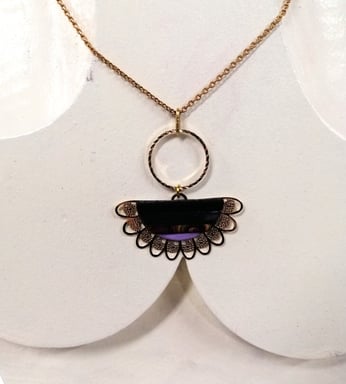 a necklace with a purple and gold necklace