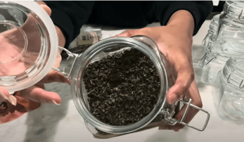 a person holding a jar of lemon balm herb