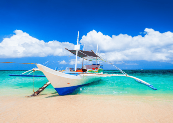 A cozy small boat on a very beautiful island with white sand and crystal clear blue sea in Boracay 