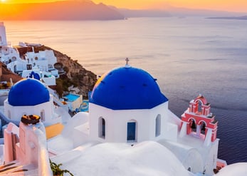 The famous blue dome churches in Greece, overlooking the sea in the beautiful Santorini travel