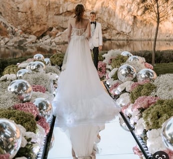 Elegant mirror silver balls reflecting ambient lighting at a luxurious Santorini event.