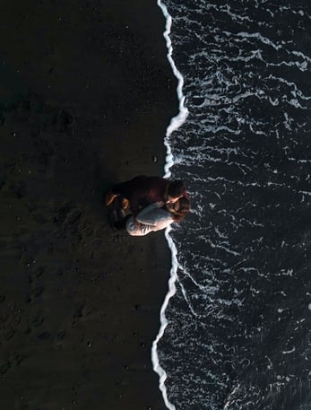 Couple standing on a beach with an areal view