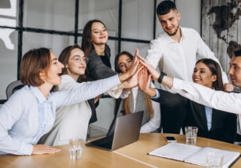 a group of business people giving high five fingers up