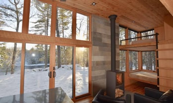 Cozy prefab modular tiny home interior with winter views.