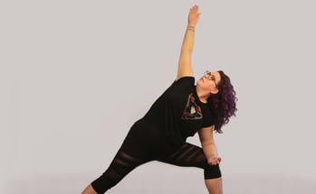rachel in yoga pose, black outfit purple hair white background