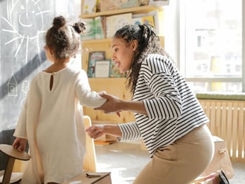 One-on-one learning session with a female tutor and young student at home.