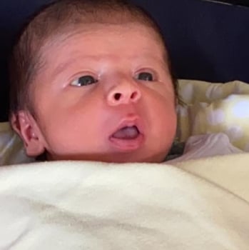 a baby in a stroller with a blanket