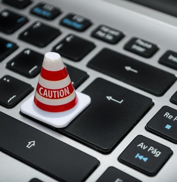 Mini caution cone on a keyboard symbolizing fast and careful product development at Braske Agency