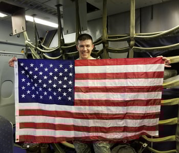 Bert, holding the American flag while on a KC-10 Tanker during his last deployment