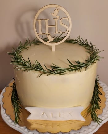 a cake with a wooden sign that says hhs