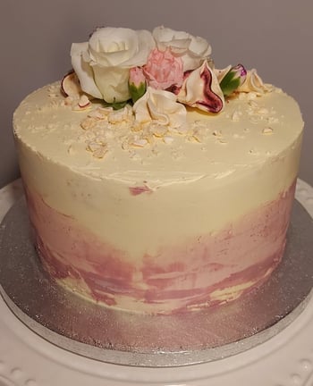 a cake with flowers on top of a white plate