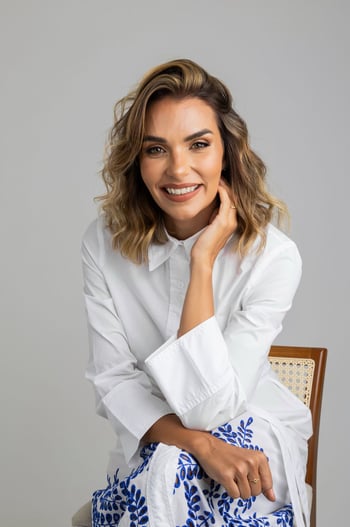 a woman in a white shirt and blue skirt