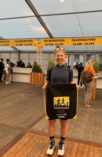 a woman holding a sign that says,'i am a runner