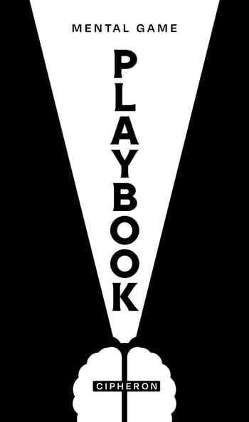 a man's hand holding a book with a white light bulb on it