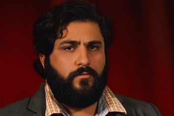 bearded man with red background