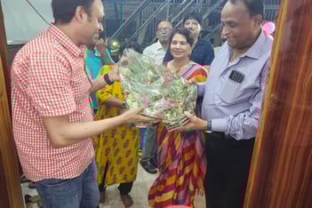 Handing a bouquet of flowers to Chief Guest