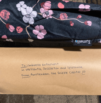 note from Tumella Flip-proof Travel Umbrella creators to customer and cherry blossom umbrella design