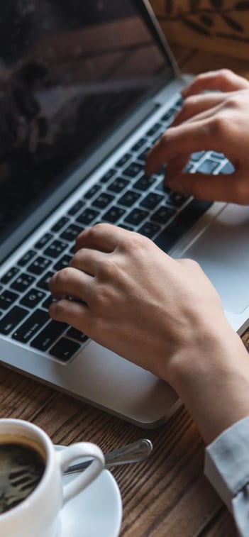 hands-working-with-laptop-representing-Pharmacovigilance-expert-support