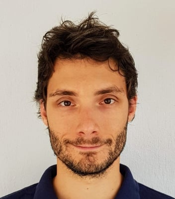 a man with a beard and a blue shirt