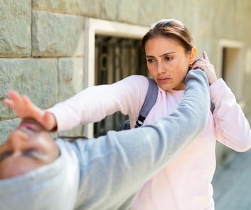 Woman diverts assailants attack and counters with a palm strike to the chin..