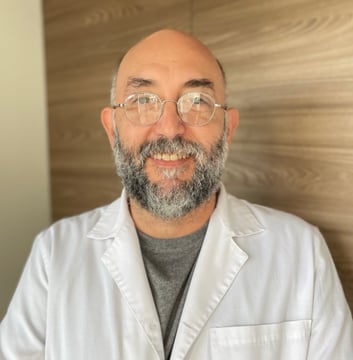 a man in a lab coat and glasses