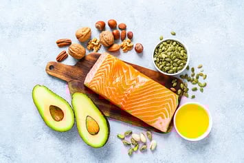 a salmon steak with avocado, nuts, nuts, and nuts