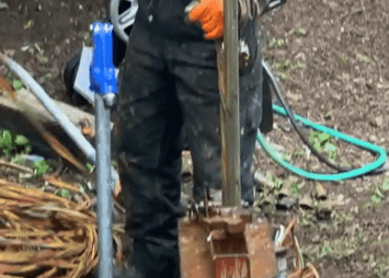 Technician snakes new well piping into hole
